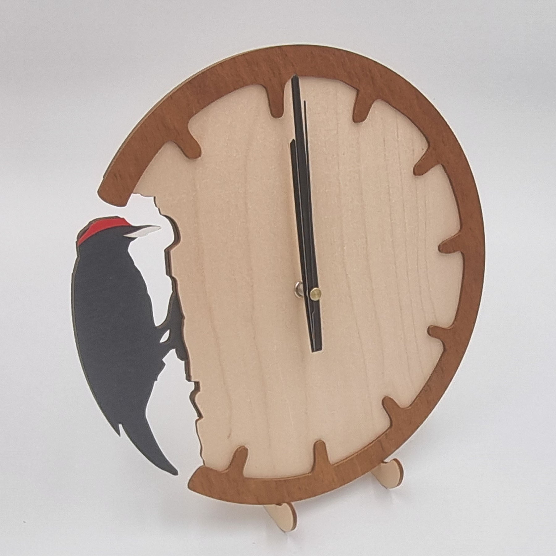 A wooden wall clock with a silhouette of a woodpecker design, featuring a natural wood finish.